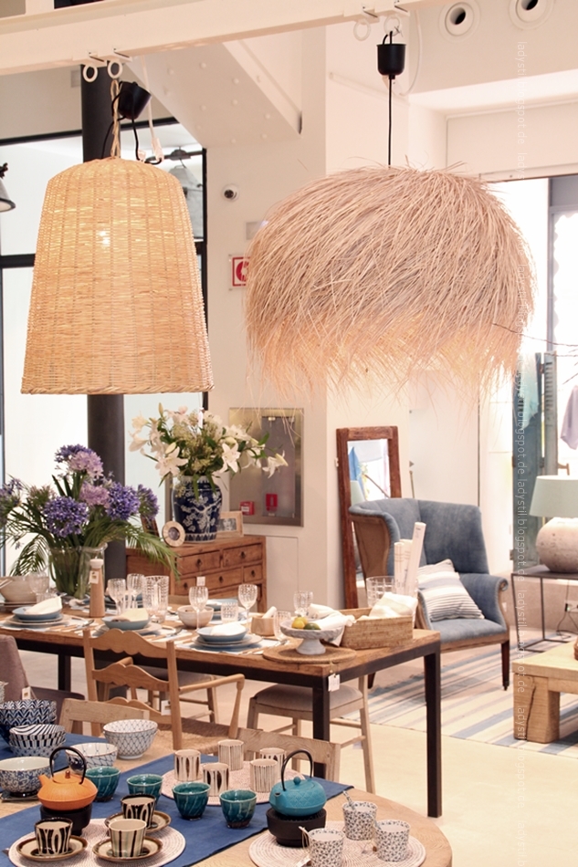 Blick ins Rialto Living mit Korblampen und gedecktem Tisch mit Wohnaccessoires